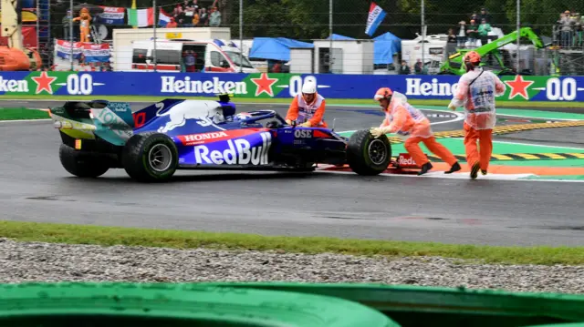 Pierre Gasly is helped back onto the track by marshalls