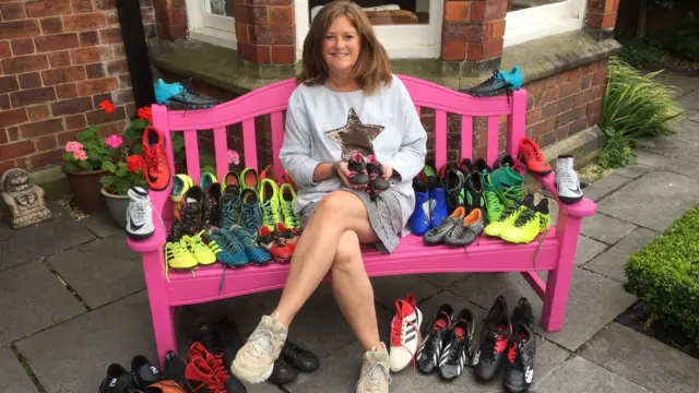 Sarah Hopper with football boots on a bench