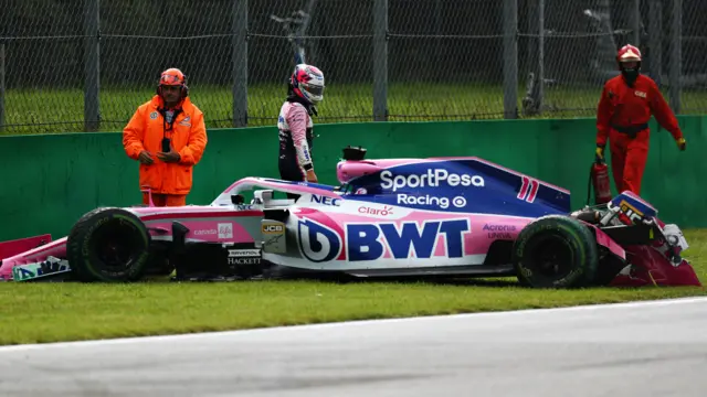 Sergio Perez assesses the damage in his Racing Point car after crashing into the wall during first practice