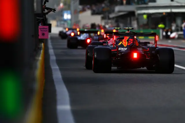 Alex Albon at the back of a queue leaving the pits at the end of Q3