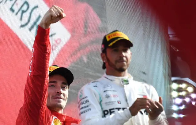 Charles Leclerc on the podiium with Lewis Hamilton