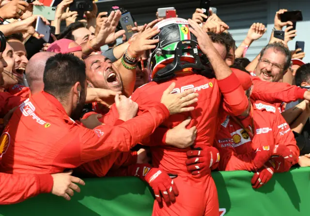 Charles Leclerc celebrates with his pit crew