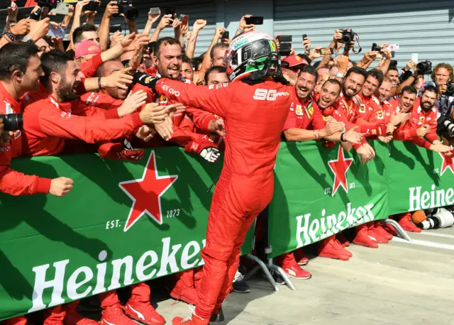 Charles Leclerc celebrates with his pit crew