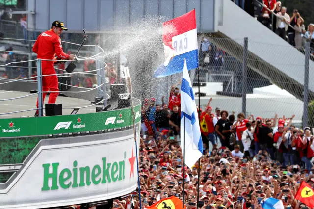 Charles Leclerc sprays the crowd with champagne