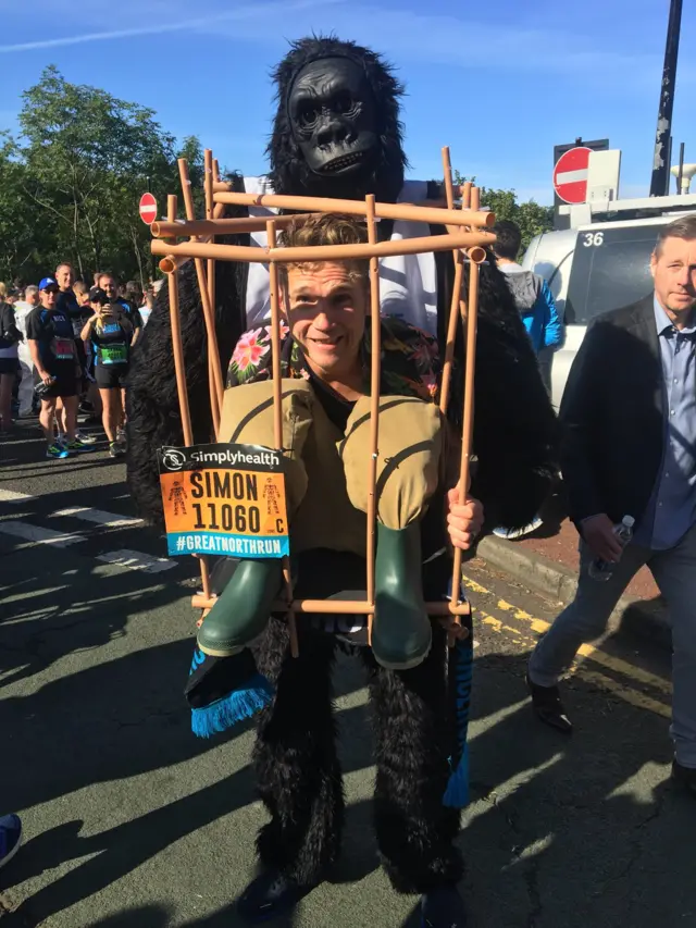 Runner dressed as gorilla and cage