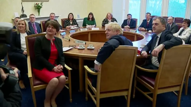 The new ministers pose for photos along with the prime minister and secretary of state at the executive table.