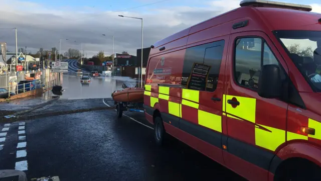 A fire van with a boat near floods