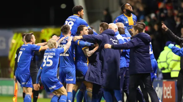 Aaron Pierre of Shrewsbury Town celebrates with his team mates