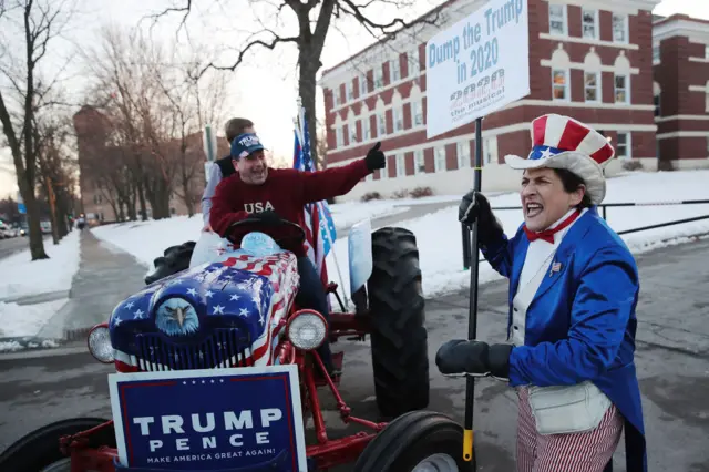 A supporter of Trump and his critics clash outside the debate in Des Moines