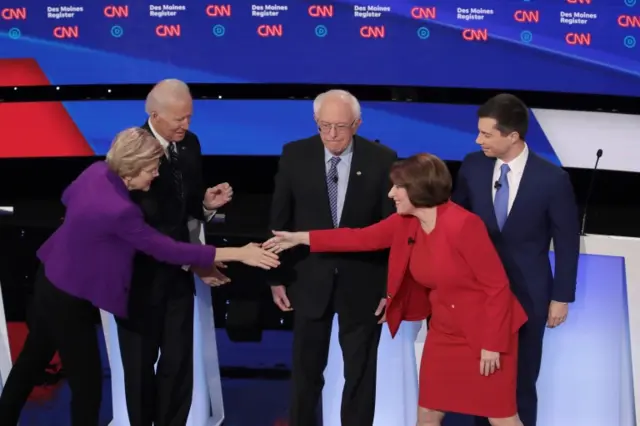 Warren and Klobuchar shake hands