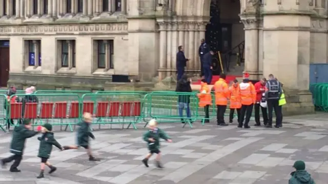 SCHOOLCHILDREN PLAYING OUTSIDE CITY HALL