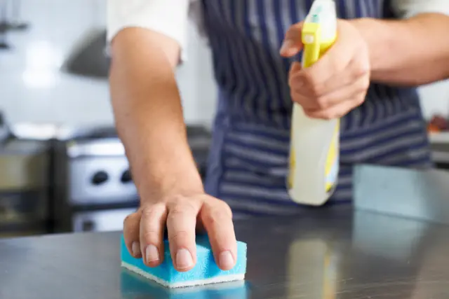 Washing a kitchen surface, stock image