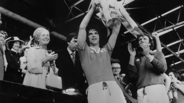 Martin Buchan lifts the FA Cup