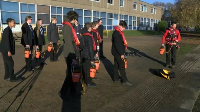 Children learning to use a throw-line