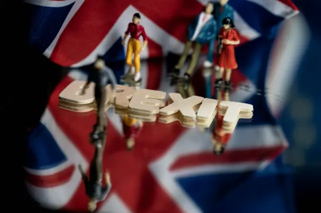 Figures of people, a union flag and the word Brexit