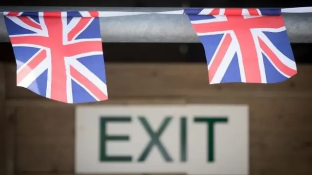 Union flags hanging over an exit sign