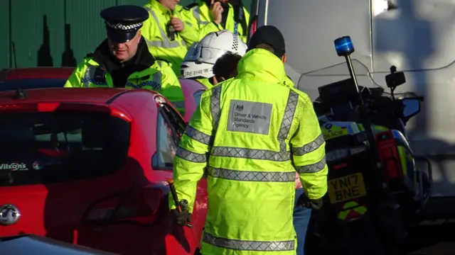 People stopping cars