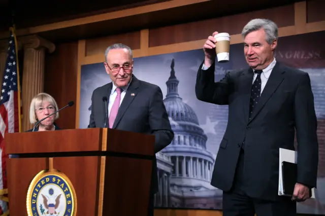 Democrat Sheldon Whitehouse (right) holds up his coffee, which is banned from the Senate floor