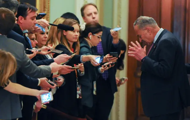 Senate Democratic leader Chuck Schumer speaks to reporters during a recess in the Senate trial