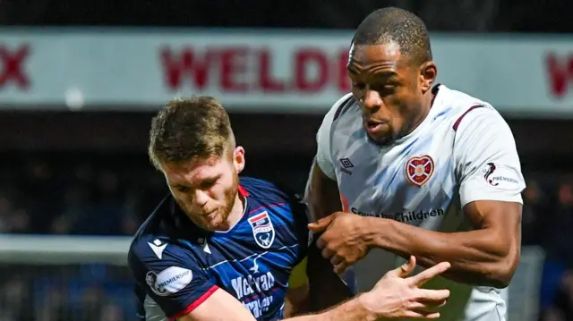 Hearts’ Uche Ikpeazu (right) and Ross County’s Marcus Fraser