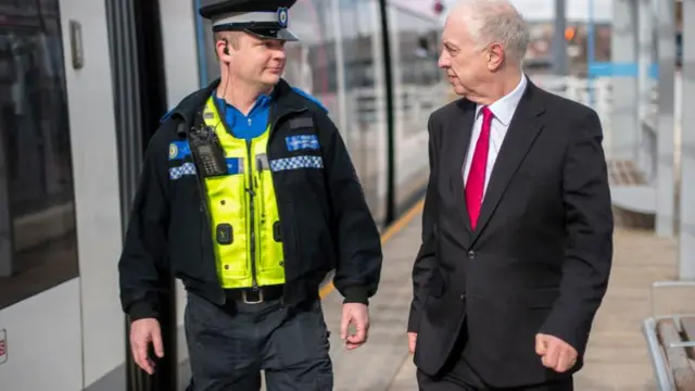 David Jamieson with an officer on a platform