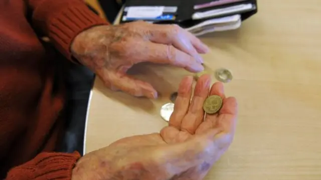 Older person counting coins