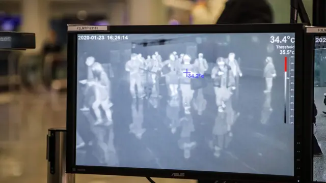 An infrared camera is used to scan the body temperatures of passengers arriving at Hong Kong airport