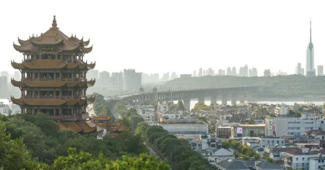 A general view of Wuhan shows the elaborate Yellow Crane Tower set against the bridge and river