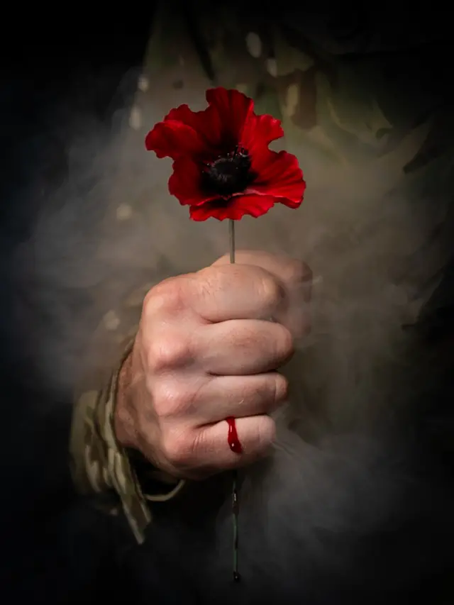 A person holding a poppy