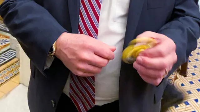 Republican Senator Mike Rounds shows his fidget spinner to reporters