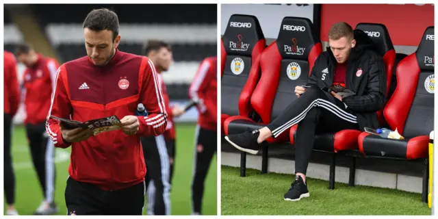 Aberdeen defender Andrew Considine and striker Sam Cosgrove reading the matchday programme