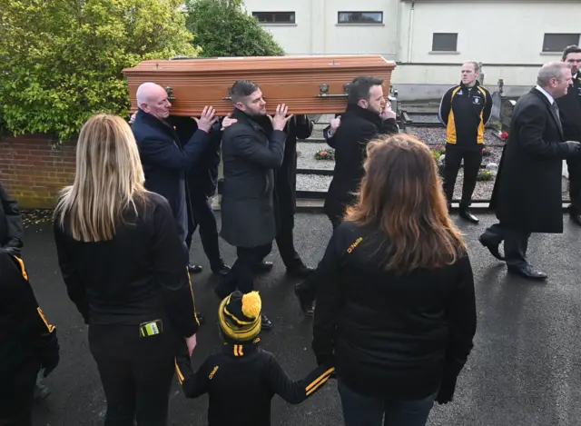 Coffin carried into the church