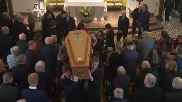 Coffin carried from the church