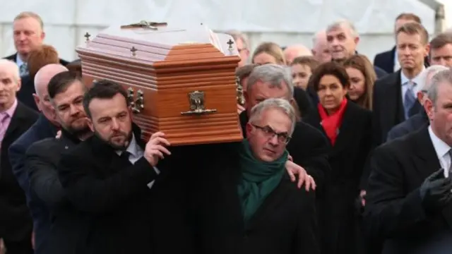 Colum Eastwood and Alex Attwood at front of group carrying Seamus Mallon's coffin