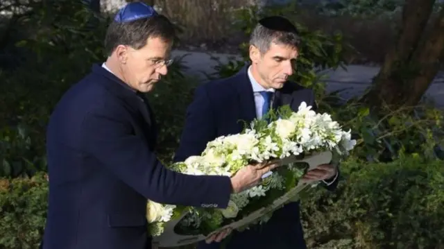 Mark Rutte, left, lay a wreath at the Holocaust remembrance event in Amsterdam