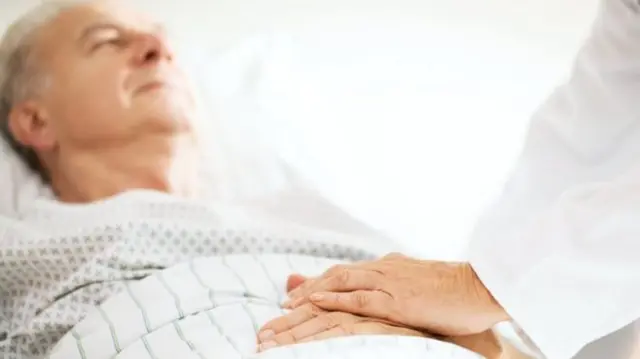 Older person in hospital bed