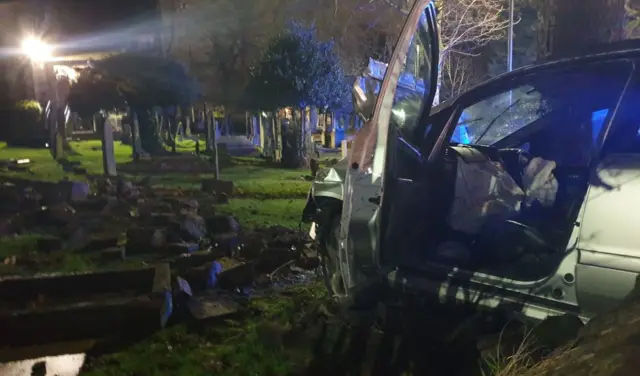 Car in graveyard