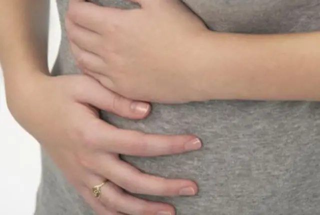 Woman holding stomach