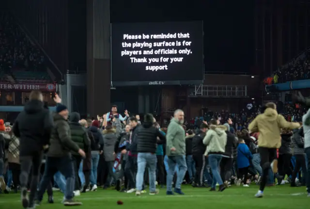 Aston Villa fans invade the pitch after the Carabao Cup Semi Final match between Aston Villa and Leicester City at Villa Park