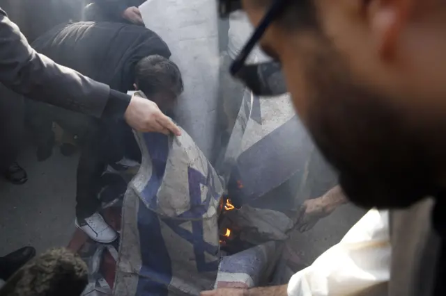 Demonstrators burn Israeli and US flags during a protest in Tehran, Iran, 03 January 2020.