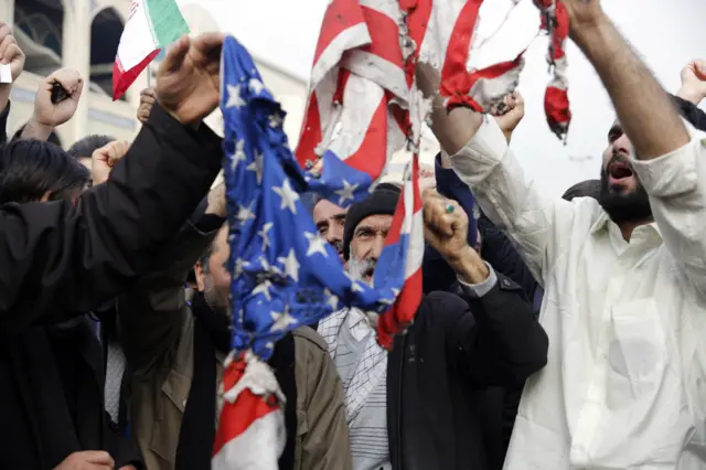 Iranians burn a US flag as thousands of people take to the streets to mourn the death of Qasem Soleimani during an anti-US demonstration in Tehran, Iran, 03 January 2020.