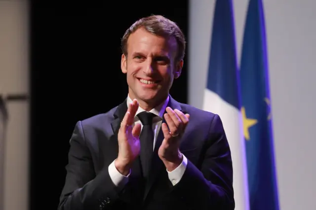 French President Emmanuel Macron claps during a festival in France