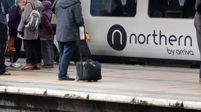 PASSENGERS WAITING FOR NORTHERN TRAIN