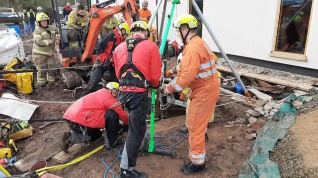 Firefighters around the well