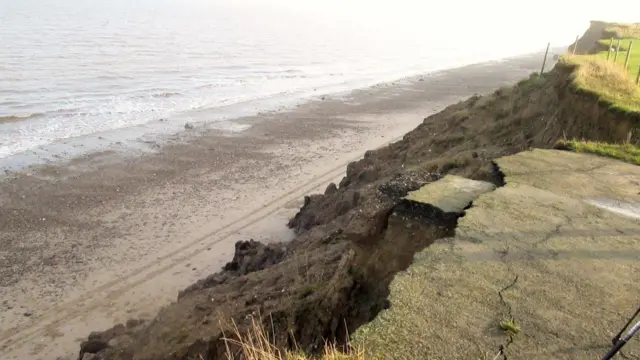 Hornsea Road going over the edge of Skipsea Cliff