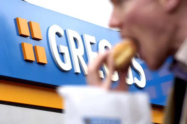 Man eating a Greggs pasty