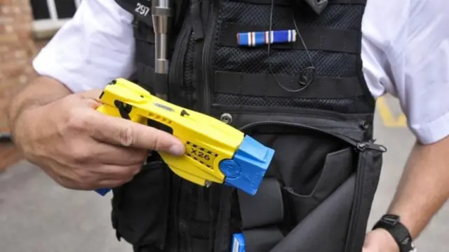 POLICEMAN USING TASER