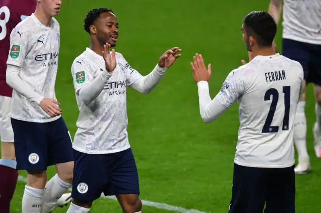 Man City players celebrating a goal against Burnley