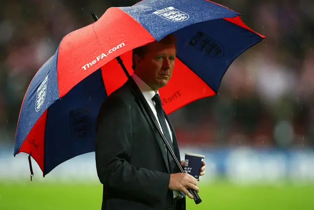 Steve McClaren under an umbrella during his final match as England manager in 2007