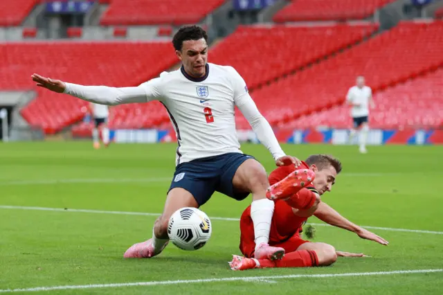 Trent Alexander-Arnold is tackled by Timothy Castagne